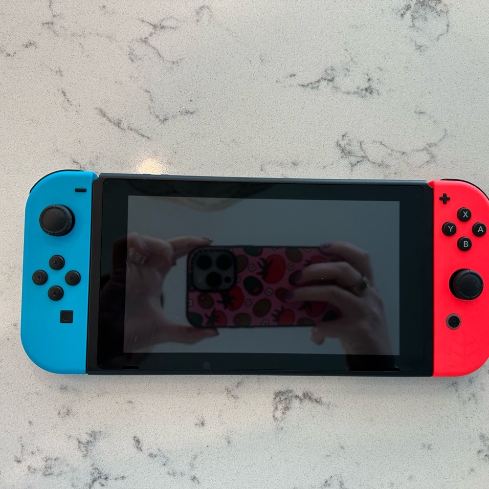 Nintendo Switch Console with Neon Blue and Red Joy-Con controllers.